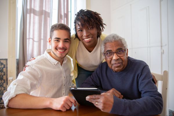 Family enjoying time together with their elderly father at home