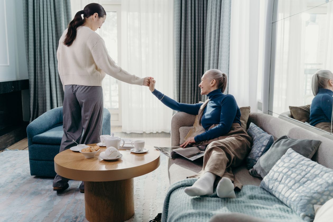 Home care companion helping a senior woman in her Bergen County, NJ living room
